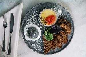 black bread croutons with hummus top view photo