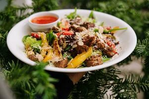 Salad with warm veal and vegetables photo