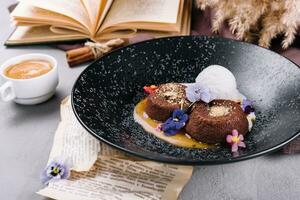 Chocolate lava cake with ice cream served on plate against cup of coffee photo