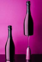 concept of two bottles and glass of pink rose champagne photo