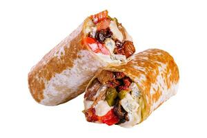 fresh roll of thin lavash or pita bread filled with grilled meat photo