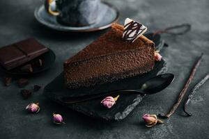 Chocolate cheesecake on black stone board photo