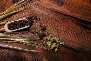 wheat with hops and cinnamon on a wooden background photo