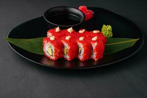 California Sushi roll cutting on black plate photo