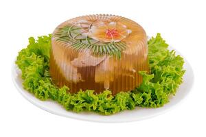 Cold appetizer, portioned jelly of pork, beef and chicken on plate photo