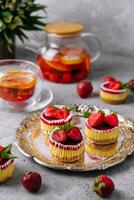 Mini strawberry cheesecake in muffin forms photo