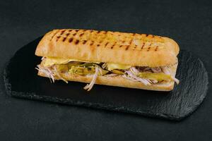 Big sandwich with chicken on stone board photo