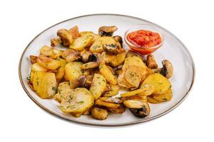 Potatoes with fried mushrooms on a plate photo