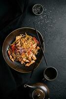 Fried noodles with chicken and vegetables photo