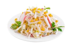 Salad with corn, crab sticks, cucumbers, eggs and mayonnaise photo