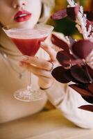 woman drinking strawberry smoothie in a restaurant photo