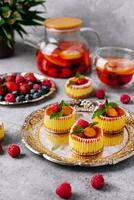 Mini cheesecake with apricot in muffin forms photo