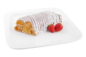 Strawberry crepes with whipped cream on plate photo