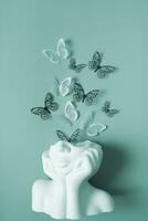 A figurine of a head with butterflies on a colored background. Mental health concept photo