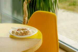 meringue roll in a disposable plate in a cafe photo