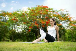 Young female with outdoor activities in the city park, Yoga is her chosen activity. photo