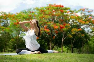 Young female with outdoor activities in the city park, Yoga is her chosen activity. photo