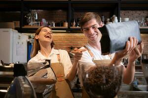 The barista fills the coffee grinder with roasted coffee beans. to prepare coffee for customers photo