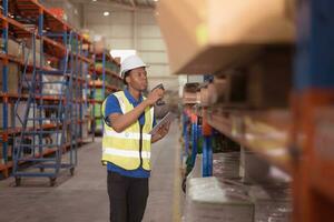 Portrait of smiling male warehouse worker using digital tablet in a warehouse photo