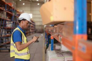 Portrait of smiling male warehouse worker using digital tablet in a warehouse photo