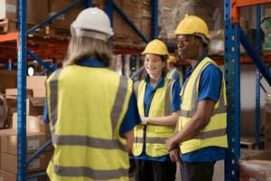 Side view of warehouse workers discussing inspecting goods brought into the warehouse for pre-stocking. photo