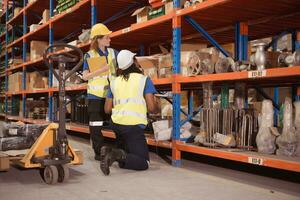 Young man and woman working together in warehouse, This is a freight transportation and distribution warehouse. Industrial and industrial workers concept photo