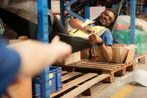 Portrait of happy mature African American man working in warehouse. This is a freight transportation and distribution warehouse. Industrial and industrial workers concept photo