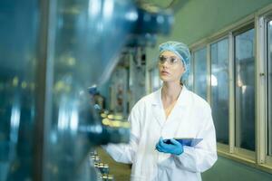 Female researcher carrying out scientific research in drinking water factory photo