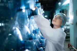 Female researcher carrying out scientific research in drinking water factory photo