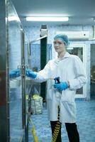 Portrait of confident female researcher carrying out scientific experiment in drink water laboratory photo