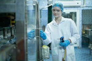 Portrait of confident female researcher carrying out scientific experiment in drink water laboratory photo