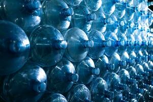 Plastic bottles of mineral water in a row, close-up photo