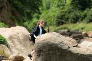 Young woman with backpack hiking in the forest. Active lifestyle concept. photo