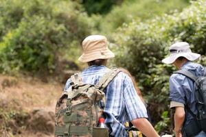 Group of friend on a sunny day in the forest Young group hiker with backpack and trekking poles photo