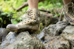 Hiking shoes on a log or rocks in the forest. photo