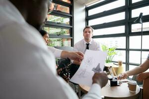 Group of diverse business people working together in the office, Brainstorming about the hand robot model to be used for production work photo