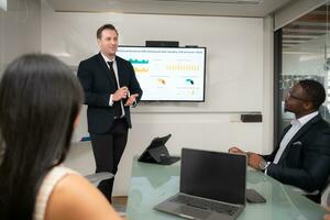 Rear view of two businesspeople having meeting around table in office photo