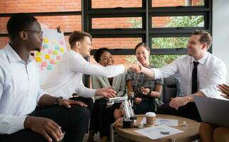 grupo de diverso negocio personas trabajando juntos en el oficina, lluvia de ideas acerca de el mano robot modelo a ser usado para producción trabajo foto