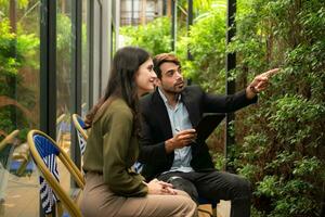 Both of businessperson using digital tablet at outdoor cafe. Business people meeting in coffee shop. photo