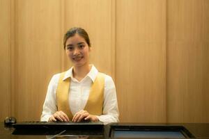 Asian ticket seller at the box office with the service of selling movie tickets to movie audiences in each round photo