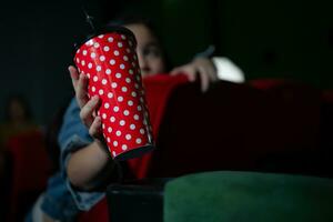 Cinema concept. People watching movie at cinema eating popcorn photo