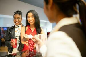 Asian ticket seller at the box office with the service of selling movie tickets to movie audiences in each round photo