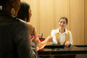 Asian ticket seller at the box office with the service of selling movie tickets to movie audiences in each round photo