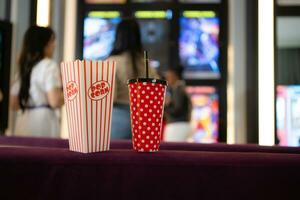 Both of young woman stand and watch the movie program to watch today. photo