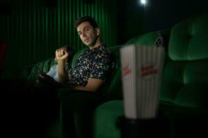 Cinema concept. People watching movie at cinema eating popcorn photo