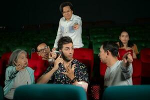 Movie etiquette, Do not talk on the phone while in the cinema, Group recreation and entertainment concept. photo