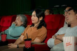 When watching scary ghost movies in theaters, moviegoers appear terrified. photo