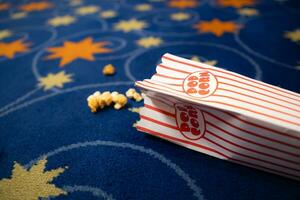 Popcorn and film strip on the blue background. photo