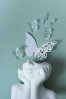 Plaster head with butterflies on a colored background. Mental health concept. World mental health day photo