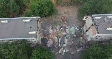 Building demolition with machinery. Aerial view of house ruins video